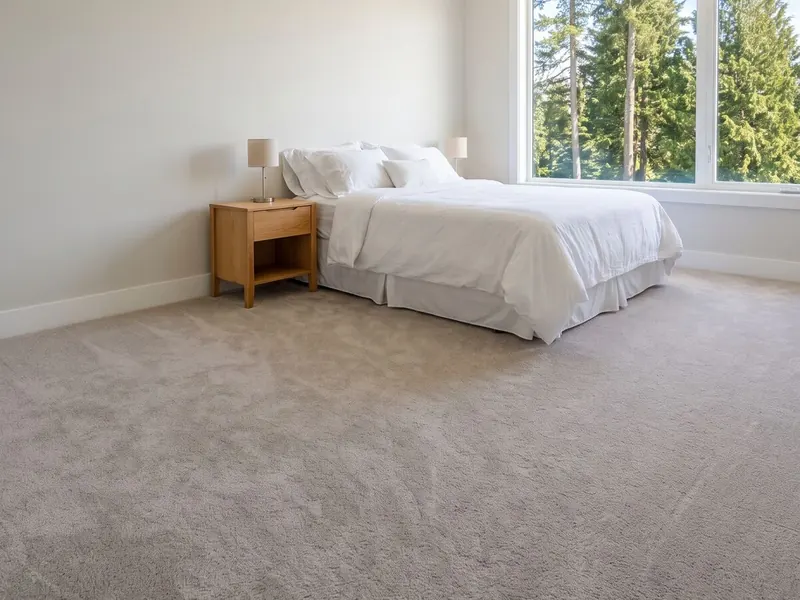 A bright bedroom with new grey carpet wall to wall