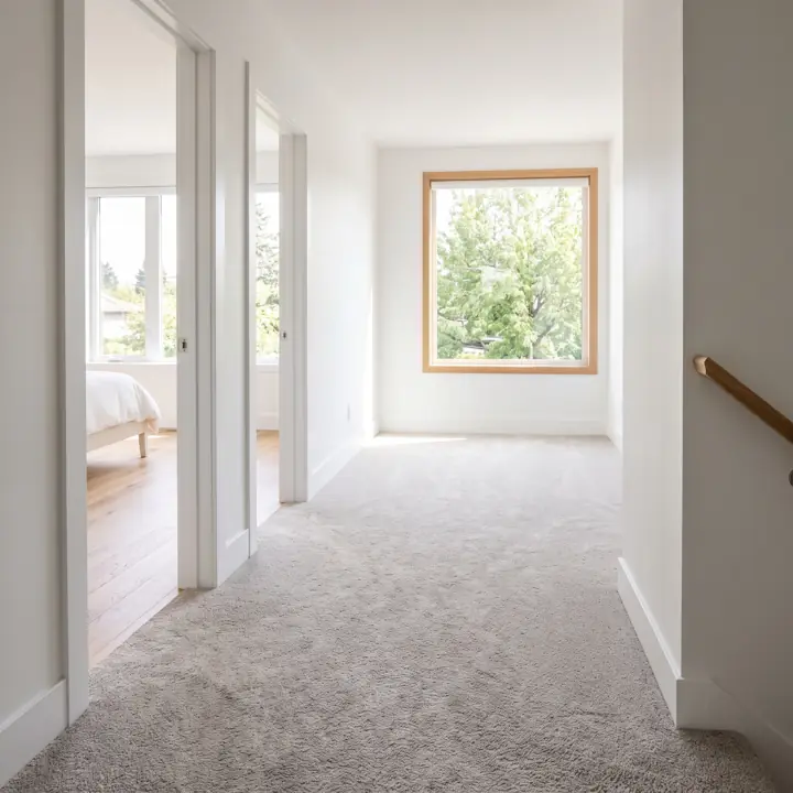 An upstairs hallway with new carpet running its full length