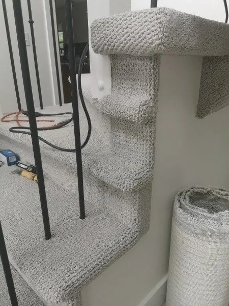 Finished stair carpet wrapped around open treads in Maple Ridge