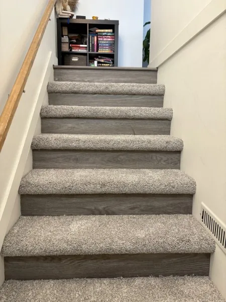 Carpet on every tread of a staircase in Mission, looking up