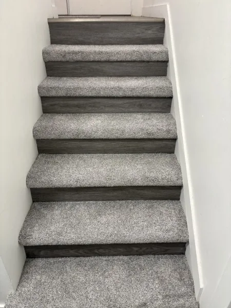 Grey carpet wrapped on every tread of a staircase in Mission