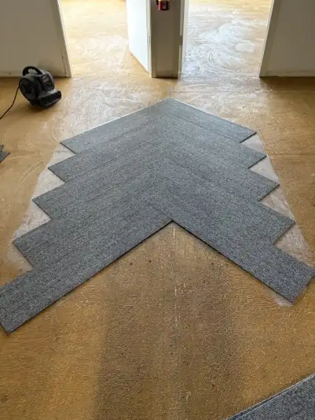 Carpet tile going down in a herringbone in Pitt Meadows