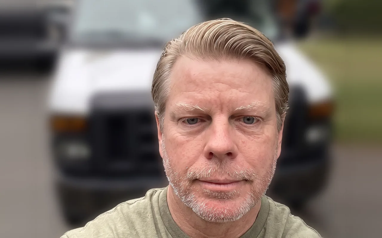 Wayne Carlson, owner of W.C. Flooring Installations, in front of his work van
